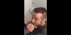 Handsome guy sucks dick in restroom stall