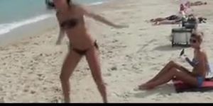 Lesbian amateur gets a hot body massage at the beach