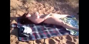 Mom Jenny masturbaties on a public beach