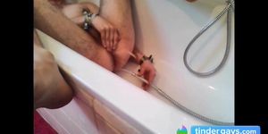 Bi-guy using shower head squirting water enema