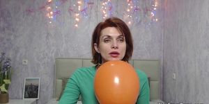 Redhead Milf plays with balloon on webcam