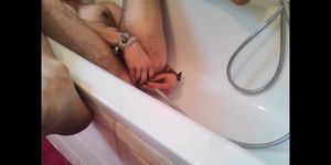 Bi-guy using shower head squirting water enema