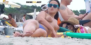 Hot nudist babe douses herself in sunscreen and rubs it all over herself