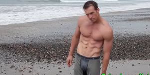 Outdoor surfer hunk tugs