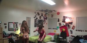 College girls playing dress up in dorm room