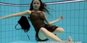 Brunette Kristy stripping underwater