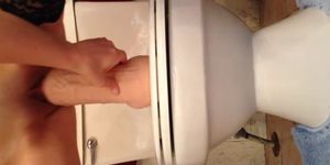Toying with huge dildo on toilet sink