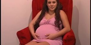 Cute pregnant brunette squeezes her nice tits and rubs 