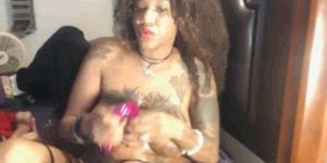 Busty pierced and tattooed ebony goddess playing with c