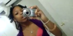 Cute black girl records herself teasing in the bathroom