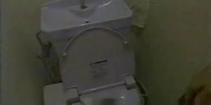 Cutie on toilet cam is sliding the finger between pussy