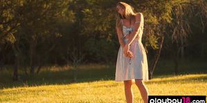 All natural teen Lillii stripping slowly on a meadow