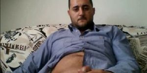 HORNY HANDSOME TURK ON SOFA BUSTING A NUTT
