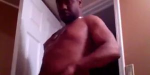 black man rubbing lotion on sexy chest!