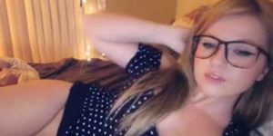 Webcam slut with glasses masturbates her shaved pussy