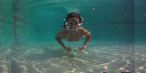 Sport chick pole dances under water in a swimming pool