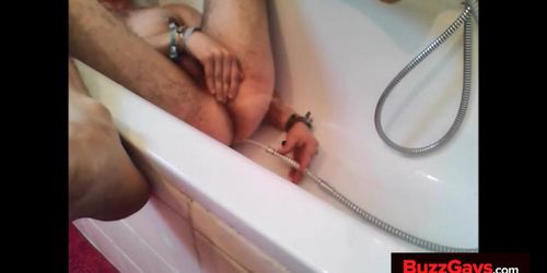 Bi-guy using shower head squirting water enema