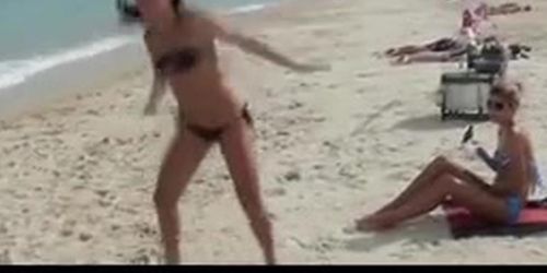 Lesbian amateur gets a hot body massage at the beach