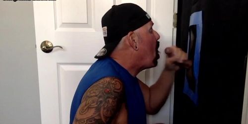 Tattooed mature gay sucks gloryhole rod with greedy mouth