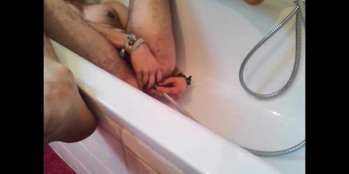 Bi-guy using shower head squirting water enema