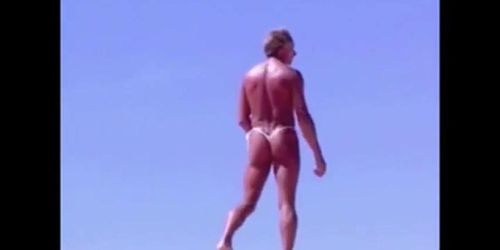 Tanned guy on beach in tiny string thong temporarily