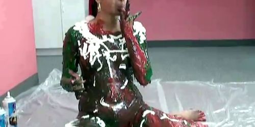 Santa girl plays with the paint