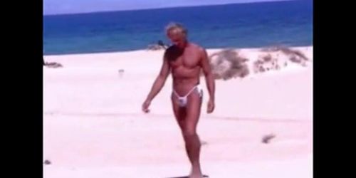 Tanned guy on beach in tiny string thong temporarily