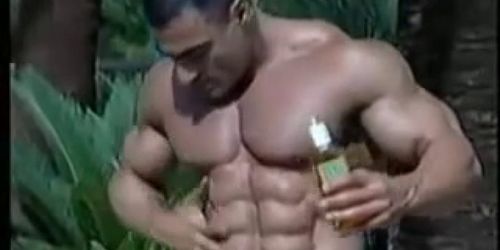 Bodybuilder oiling himself