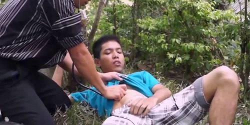 Asian doctor blows twink outdoor as first aid