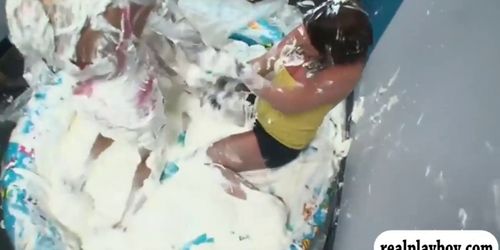 Dorm mates tag of war soaked in whipcream in inflatable