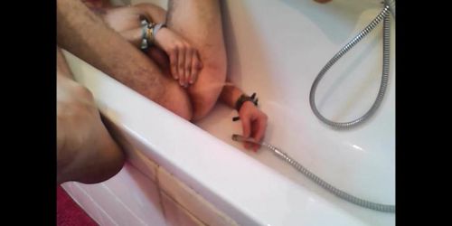 Bi-guy using shower head squirting water enema