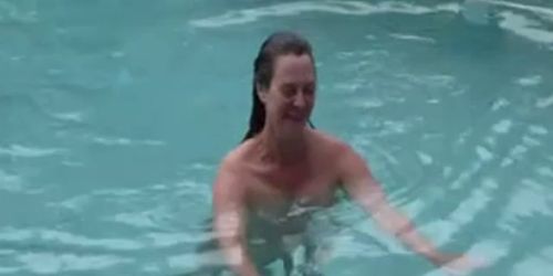 Wife having sex with husband by swimming pool