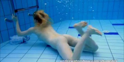 Cute Lucie is stripping underwater