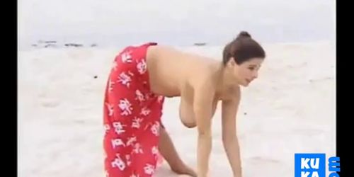 Huge boobs stretches on beach