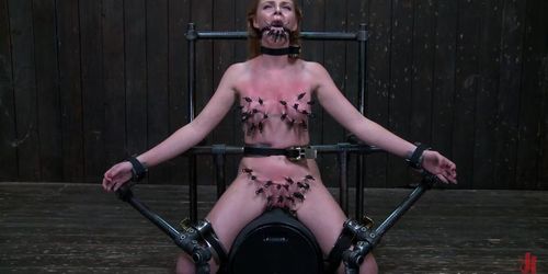 Gagged clamped sub on device bondage