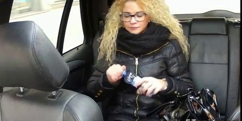 Curly haired blonde fucking in fake taxi in public