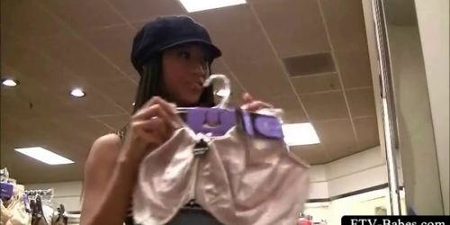 Brunette teen dares to rub her pussy in a clothing stor