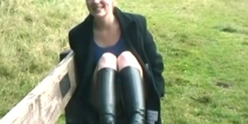 Redhead in boots flashing outdoors