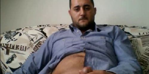 HORNY HANDSOME TURK ON SOFA BUSTING A NUTT