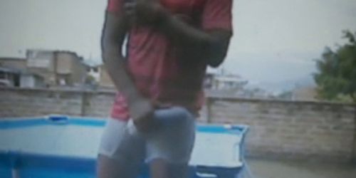 guy on roof outside rubbing huge bulge