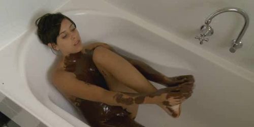 Brunette masturbates with chocolate