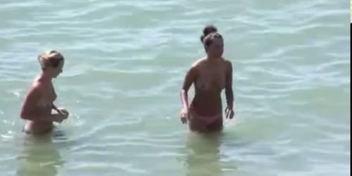 Watch these smooth nudists play at a public beach