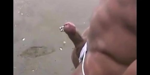 Asian bodybuilder barely covered at the beach