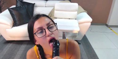 cute nerdy girl with glasses and nice bod sucks on a di