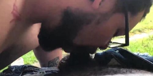 Bearded bear sucks black cock outdoor