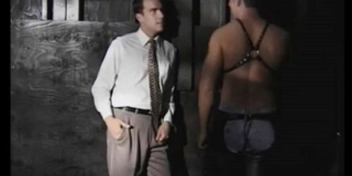 two leather men fucking in a dark room