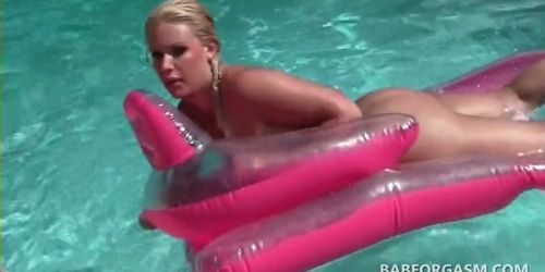 Blonde tanning in the pool fucks herself with a sex toy