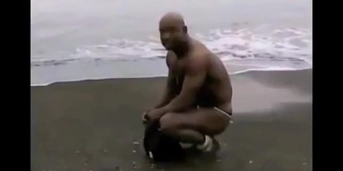 Asian bodybuilder barely covered at the beach