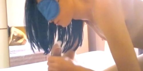 Sexy brunette in mask sucks cock in a rubber