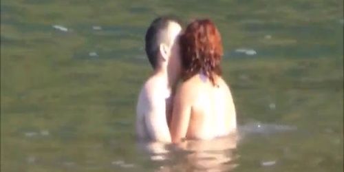 Horny couple having some fun in the water at the beach